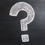 A conceptual image featuring a question mark drawn on a chalkboard, ideal for problem-solving contexts.
